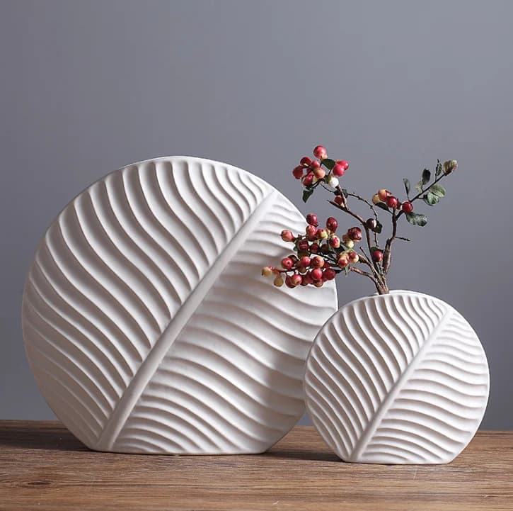 Leaf-shaped home decor ornament: a modern, minimalist white ceramic vase and decorative art piece.