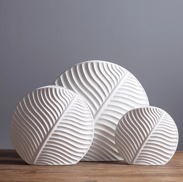 Leaf-shaped home decor ornament: a modern, minimalist white ceramic vase and decorative art piece.