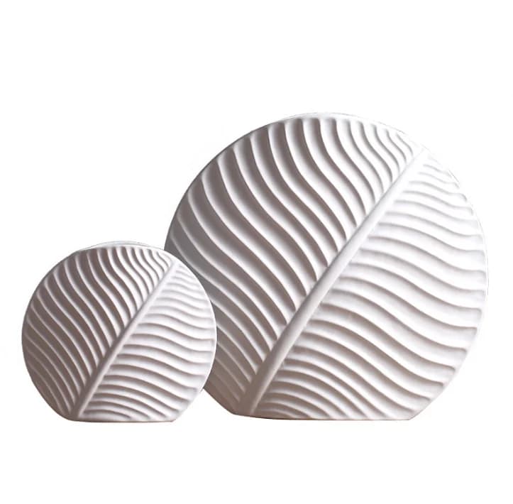 Leaf-shaped home decor ornament: a modern, minimalist white ceramic vase and decorative art piece.