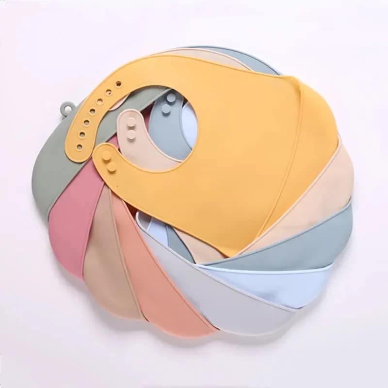 The baby feeding bib is made of silicone and has a water-resistant design. It is suitable for feeding purposes.