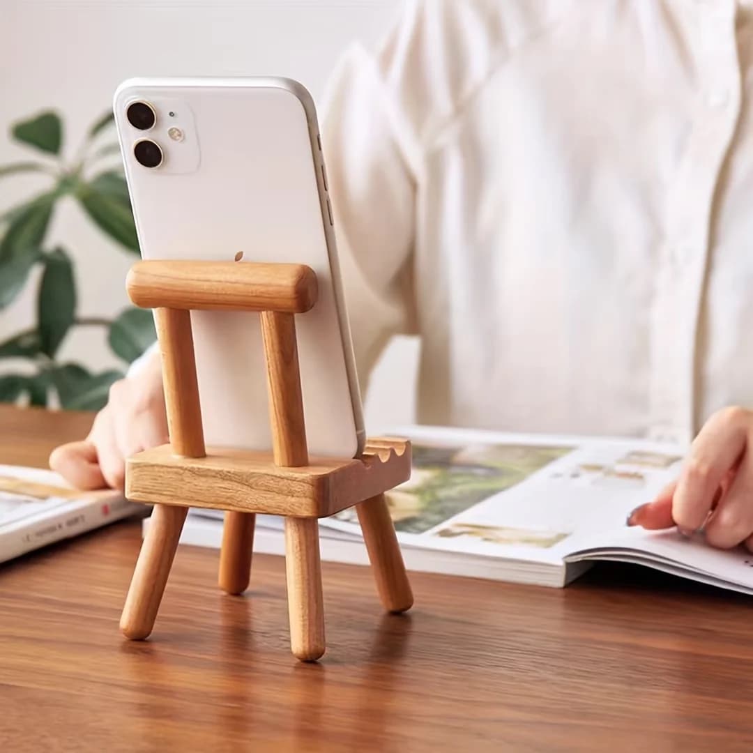 A chair-shaped mobile phone stand with three slots for stable support, suitable for large, medium and small-sized mobile phones