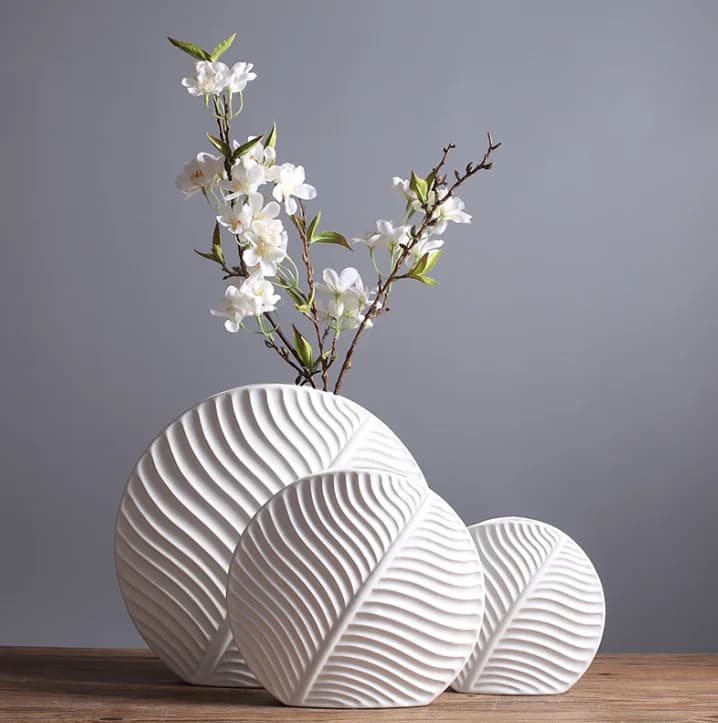 Leaf-shaped home decor ornament: a modern, minimalist white ceramic vase and decorative art piece.