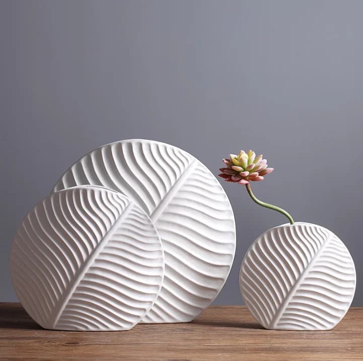 Leaf-shaped home decor ornament: a modern, minimalist white ceramic vase and decorative art piece.
