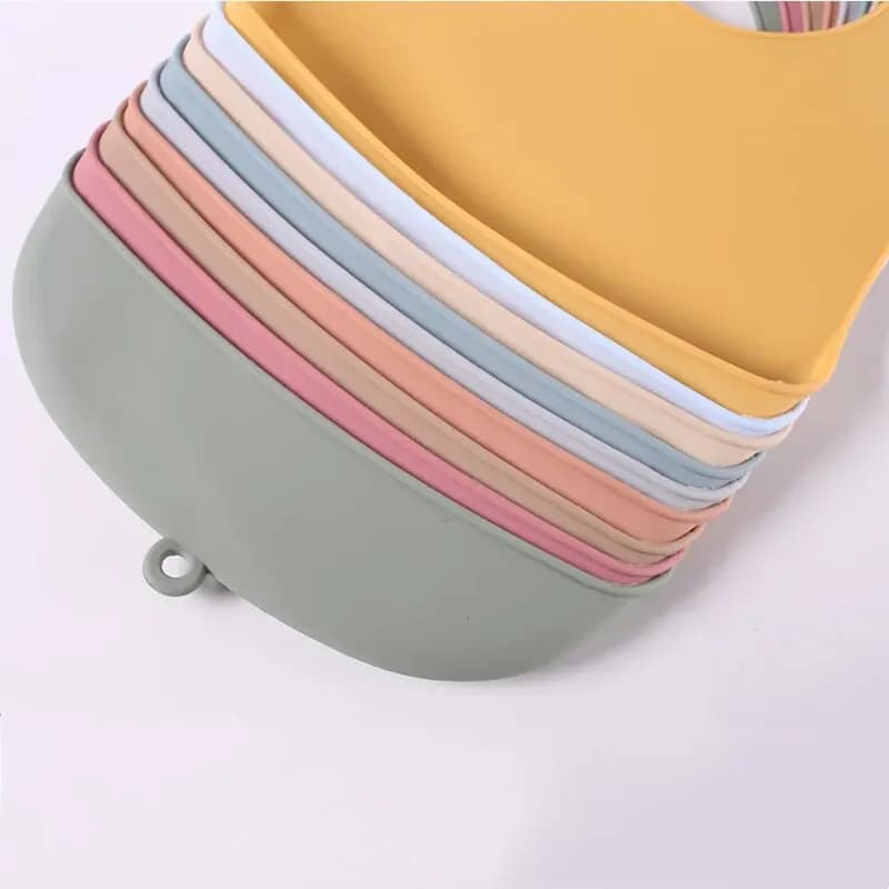 The baby feeding bib is made of silicone and has a water-resistant design. It is suitable for feeding purposes.