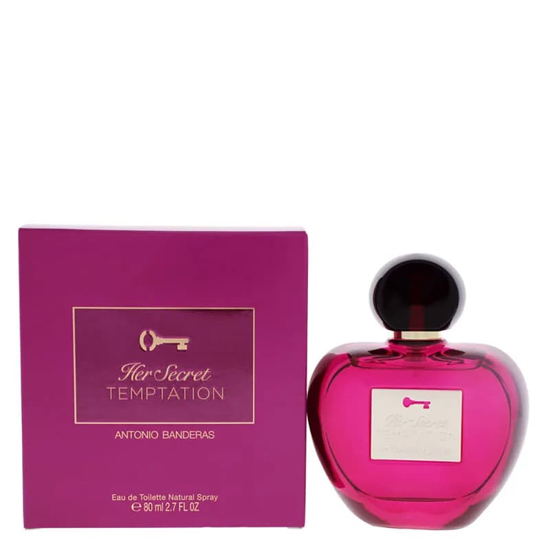 Pink heart-shaped perfume bottle with black cap next to purple box.